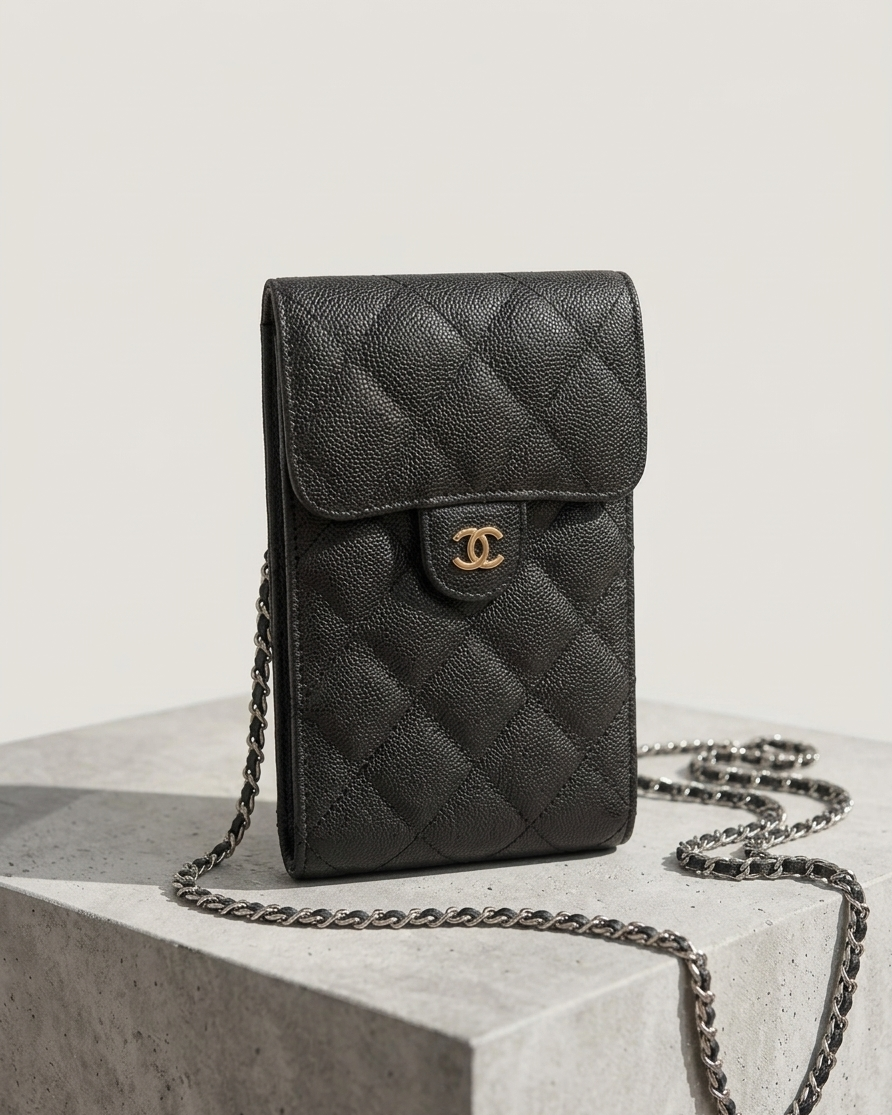 Chanel VIP Gift black quilted caviar mini crossbody bag on minimalist stone background